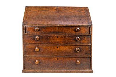 Lot 1140 - A late George III oak bureau.