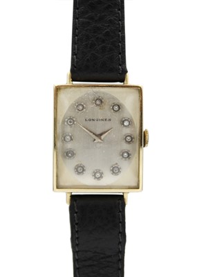 Lot 105 - LONGINES - A 14ct rectangular cased lady's manual wind wristwatch with diamond set dial.