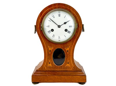 Lot 571 - An Edwardian mahogany and inlaid balloon-shaped mantel clock.