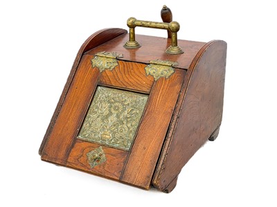 Lot 114 - A late Victorian aesthetic movement elm and brass coal scuttle.