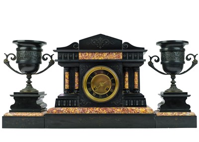 Lot 565 - A French black slate and marble clock garniture.