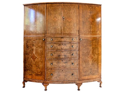 Lot 618 - A burr walnut and crossbanded bow front wardrobe.