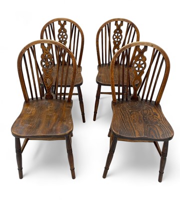 Lot 1270 - A set of four elm Windsor hoop and stick back chairs.