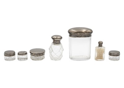 Lot 61 - A collection of six silver lidded cut glass dressing table jars.