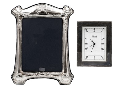 Lot 65 - A modern silver photo frame and a silver framed timepiece by Harrods.