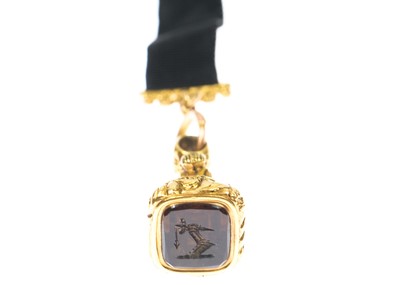 Lot 72 - A Victorian high purity gold (tests 18ct) seal fob on a gold-mounted black ribbon.