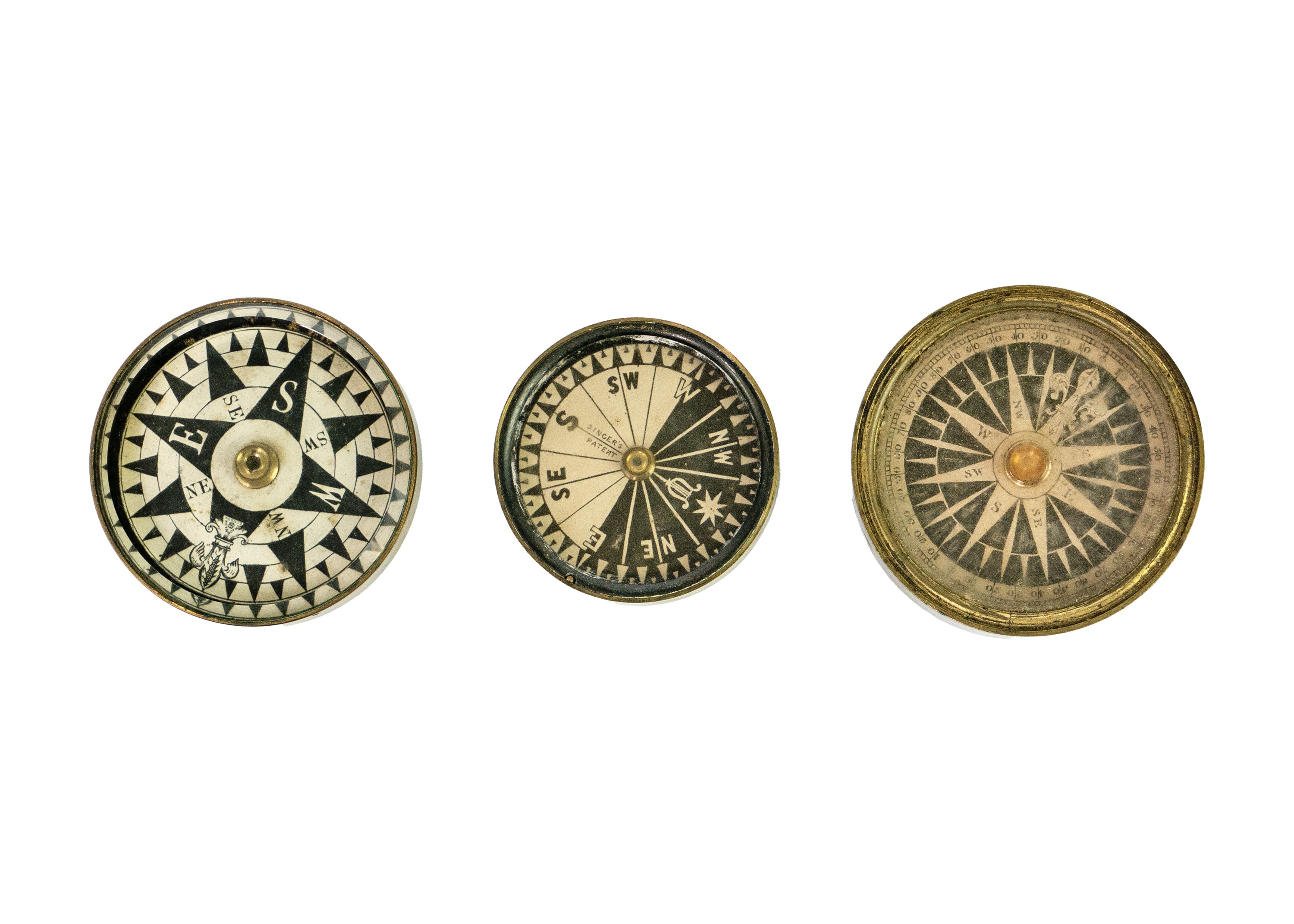 Left Compass Lot 289 - A Singers Patent brass compass.