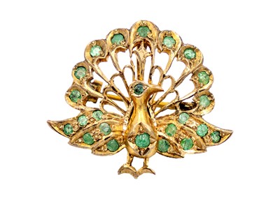 Lot 80 - An Indian gilt metal emerald set peacock design brooch pendant.