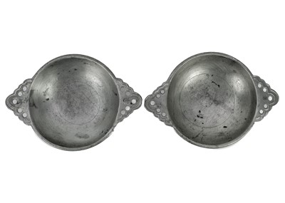 Lot 75 - A set of seven 20th century twin handle pewter porringer bowls with pierced handles.