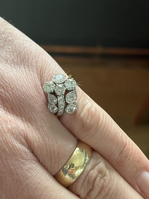 Lot 228 - An exquisite Art Deco 18ct gold and platinum diamond set floral design ring.