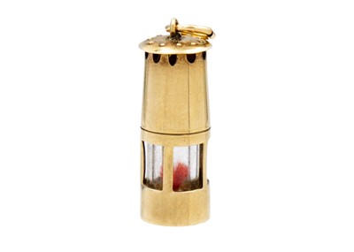 Lot 113 - A 9ct charm in the form of a miner's lamp.