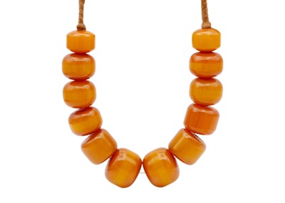 Lot 294 - A large butterscotch egg yolk amber bead necklace.