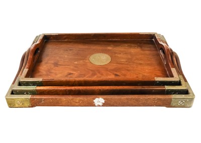Lot 90 - A set of three graduated Chinese hardwood and brass trays.