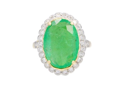 Lot 115 - An 18ct 6.99ct emerald and diamond set cluster ring.