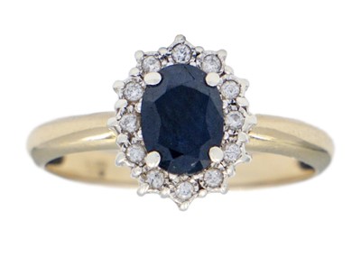 Lot 126 - A 9ct diamond and sapphire set cluster ring.