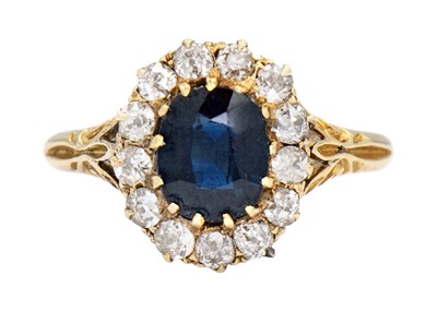 Lot 142 - An 18ct early 20th century diamond and blue sapphire cluster ring.