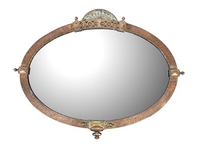 Lot 493 - A planished copper oval wall mirror.