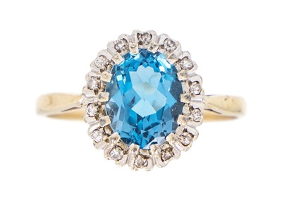 Lot 143 - A 9ct blue topaz and diamond set cluster ring.