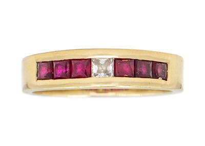 Lot 150 - A 14ct half hoop ring channel set with rubies and a white stone.