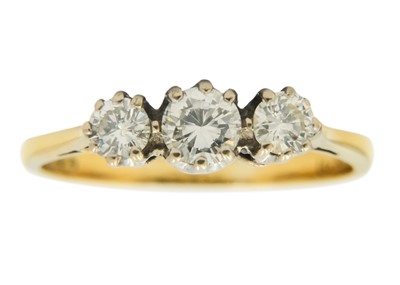 Lot 203 - An 18ct diamond set three-stone ring.