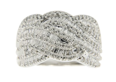 Lot 186 - A 9ct white gold diamond set wave design dress ring.