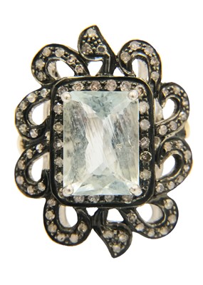 Lot 195 - A silver and gilt emerald cut aquamarine and diamond set dress ring.