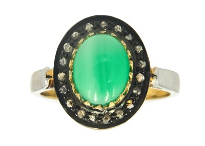 Lot 109 - A green onyx and diamond halo ring, set in silver and gilt.