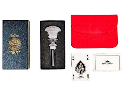 Lot 311 - A Longchamps cased set of playing cards and a Rosenthal for Versace glass bottle stopper.