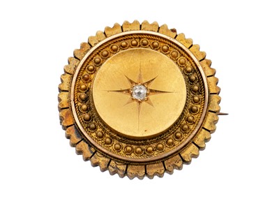 Lot 201 - A Victorian Etruscan Revival high purity gold diamond set brooch.