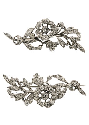 Lot 214 - Harold A Lazarus - A pair of silver clear paste set foliate design brooches.