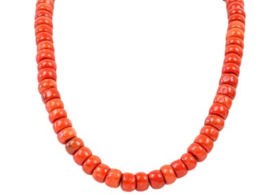 Lot 1005 - A Tibetan red coral bead necklace.