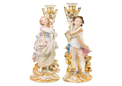 Lot 1483 - A pair of French porcelain candlestick figures.