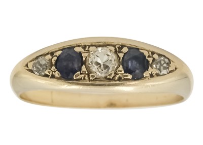 Lot 222 - An 18ct diamond and sapphire set five stone boat shaped ring.