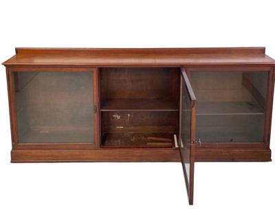 Lot 955 - A mahogany glazed low bookcase, circa 1900.