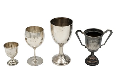 Lot 129 - A group of four silver pedestal cups.