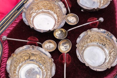 Lot 26 - A Victorian silver set of four salts and spoons within original fitted case by Hilliard & Thomason.