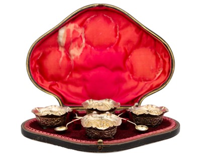 Lot 26 - A Victorian silver set of four salts and spoons within original fitted case by Hilliard & Thomason.