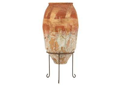 Lot 120 - A terracotta olive jar on metal stand.