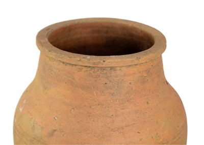Lot 118 - A terracotta olive jar on metal stand.