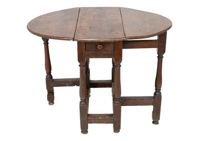 Lot 1058 - A George II oak drop leaf table.