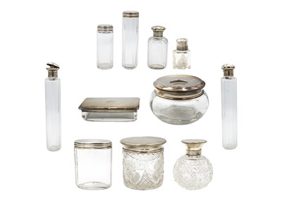 Lot 183 - A collection of silver topped bottles and jars.