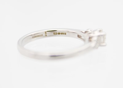 Lot 48 - A 9ct white gold diamond solitaire ring by Emmy of London.
