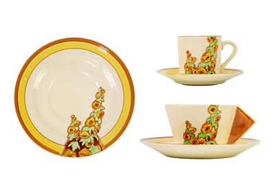 Lot 155 - A Clarice Cliff Sunshine pattern conical shape tea cup and saucer.