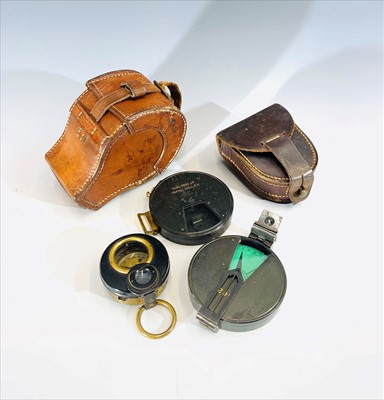 Lot 107 - A military compass and a clinometer in a brown...