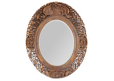 Lot 252 - An Indian Sandalwood oval wall mirror, early 20th century.