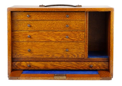 Lot 62 - An oak stationary cabinet, early-mid 20th century.