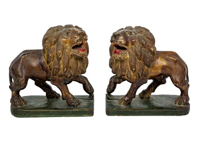 Lot 1036 - A pair of painted hardwood figures of lions.