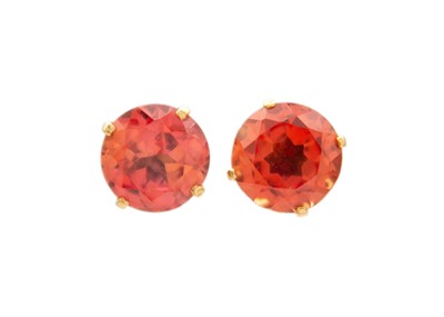 Lot 6 - A pair of gold, orange sapphire set, stud earrings.