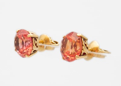Lot 6 - A pair of gold, orange sapphire set, stud earrings.