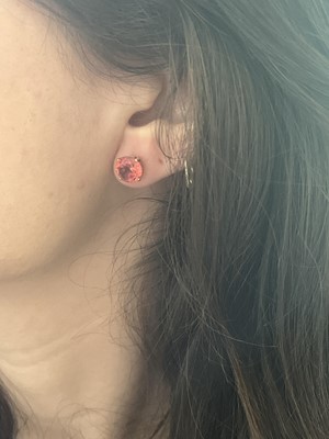 Lot 6 - A pair of gold, orange sapphire set, stud earrings.
